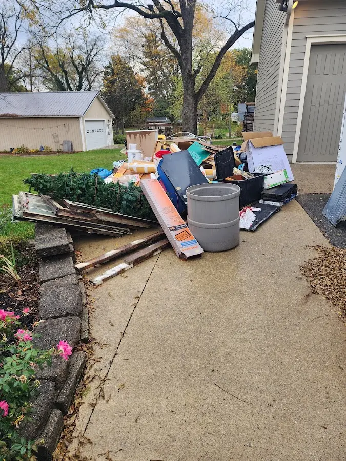 Dumpster being loaded with debris for 30 Yard Dumpster Rental in Lansing